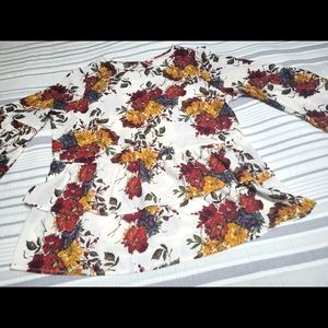 Blouse white w/ red/gold/purple floral. Ruffle bottom and bell sleeves